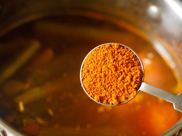 sambar powder being added