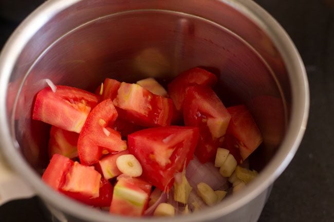 chopped onions tomatoes ginger and garlic in a blender jar