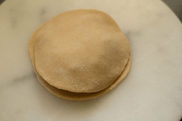 adding second round of paratha on top of the aloo filling.