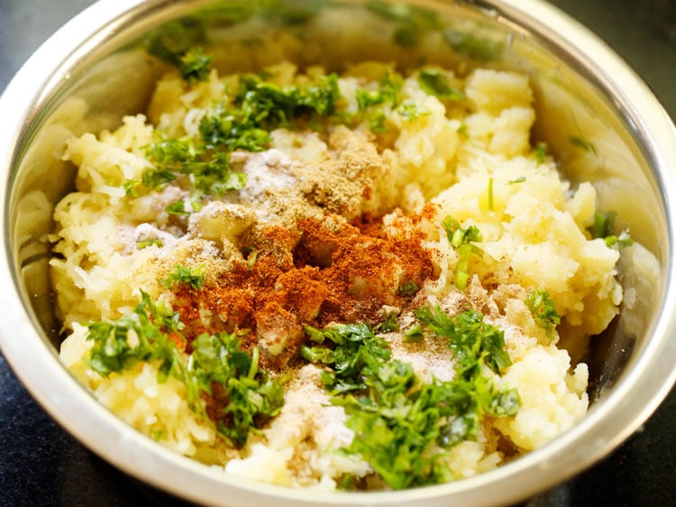 spices, herbs and salt added to mashed potatoes