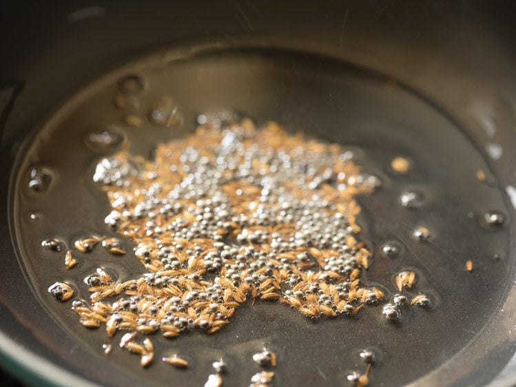 frying cumin seeds and mustard seeds in oil