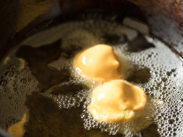 frying batata vada in hot oil