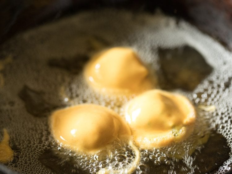 frying batata vada in hot oil