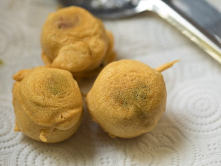 fried batata vada on kitchen paper towels