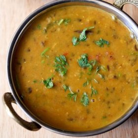 dhaba dal garnished with chopped coriander leaves and served in a copper bowl