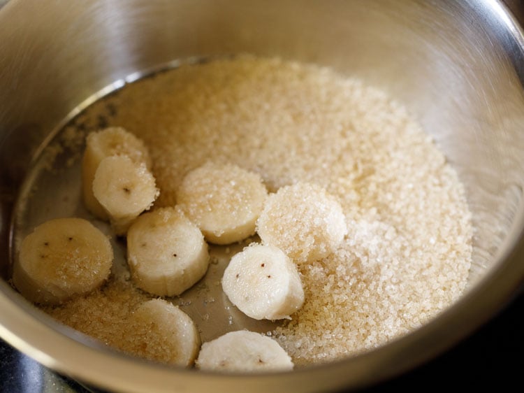 chopped banana and sugar in a mixing bowl.