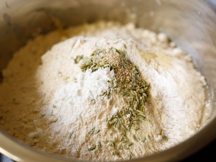 added flour, baking powder, cardamom powder, fennel seeds, salt to the mashed bananas.