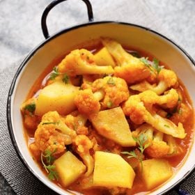 instant pot aloo gobi served in a small white wok on a grey jute mat