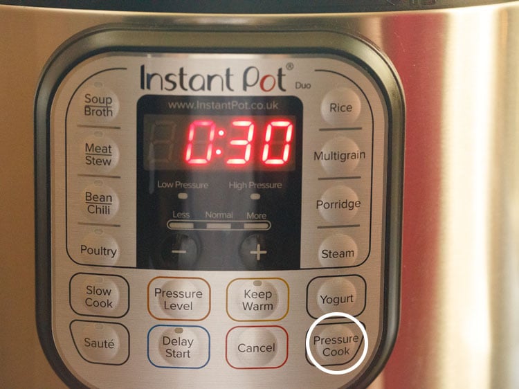 front panel of the instant pot with 30 minutes displayed in the time panel and pressure cook button encircled with a white circle. 