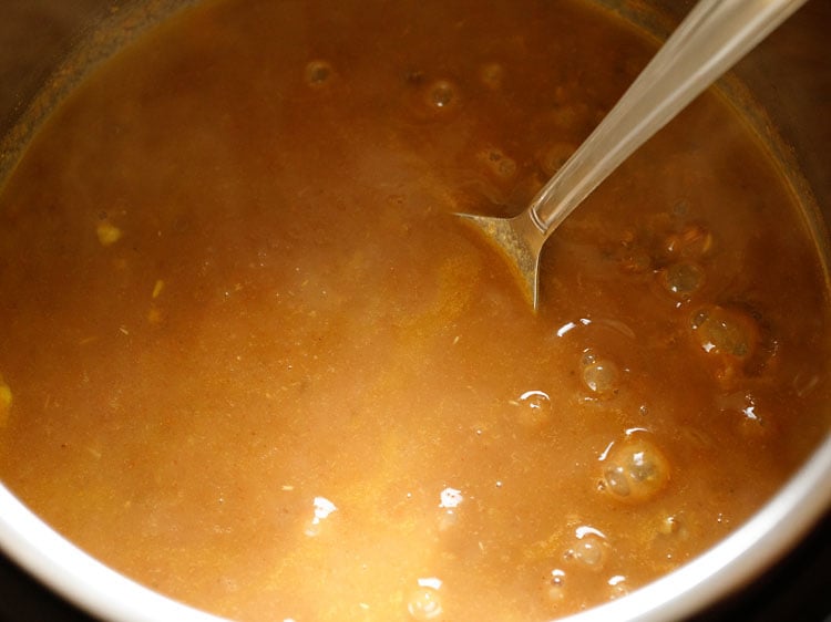 mixing and mashing lentils with a spoon