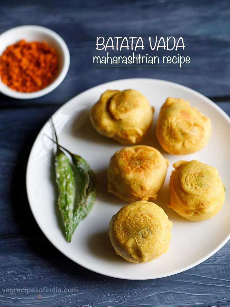 batata vada served with green chillies on a plate