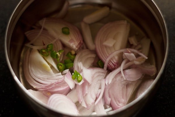 sliced onions and green chilies in a bowl