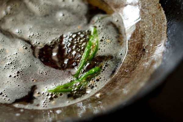 frying chillies for serving with onion pakora