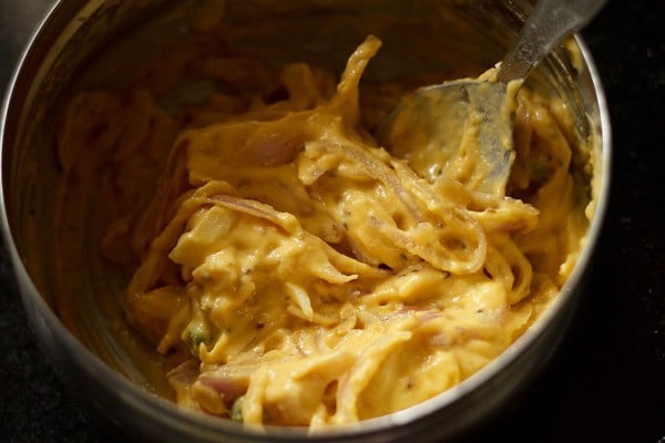 onion pakora batter in a bowl