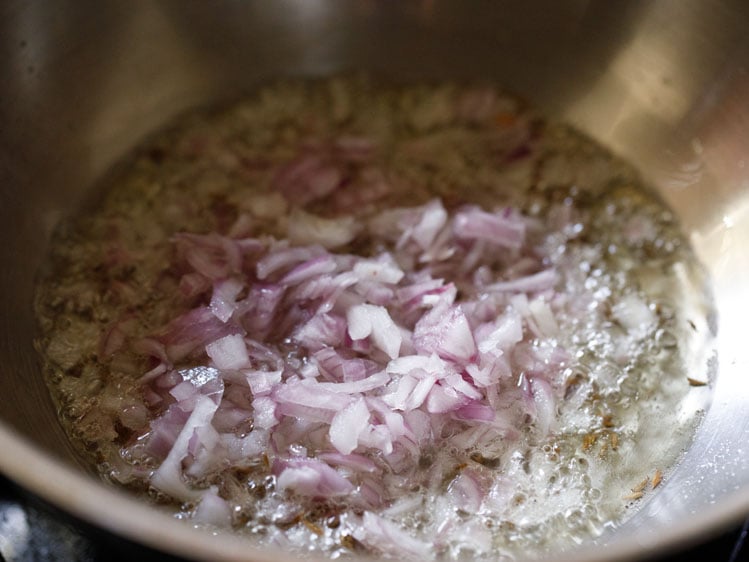 chopped onions added to pan for paneer bhurji recipe. 