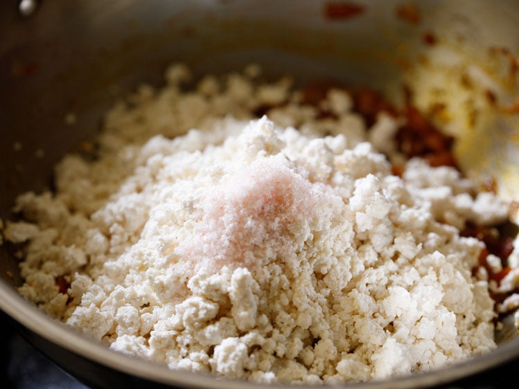 crumbled paneer and salt added to the onion-tomato masala. 