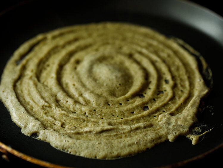 batter spread on a hot tawa/skillet