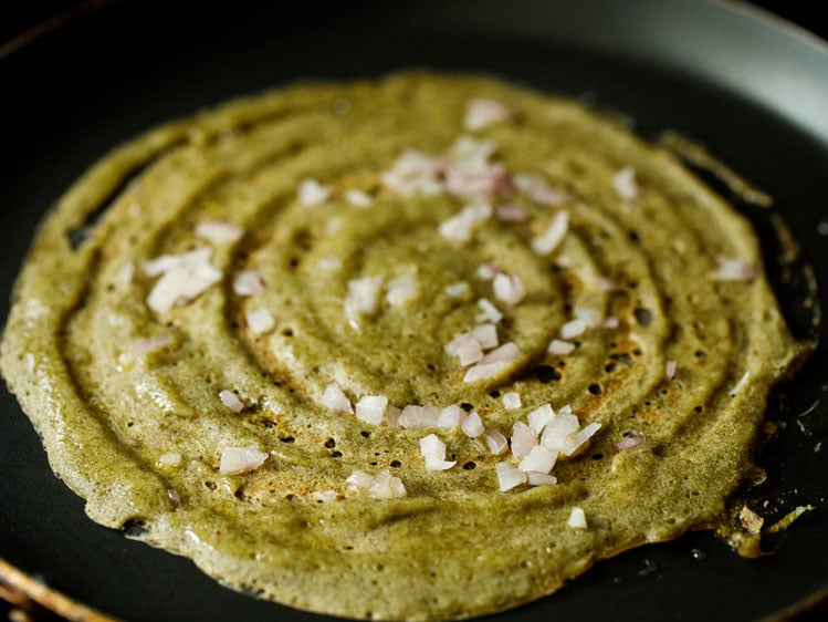 moong dal dosa topped with onions