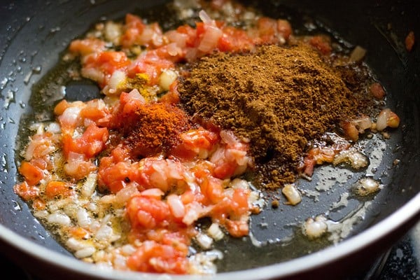 adding chole masala or chana masala powder to softened onions and tomatoes
