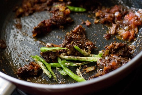 green chiles added to onion-tomato-ginger mixture for making Punjabi chole masala recipe