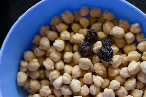 dried amla added to bowl with chole for chana masala recipe