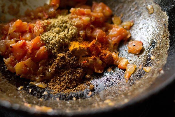 spice powders added to masala mixture in the pan