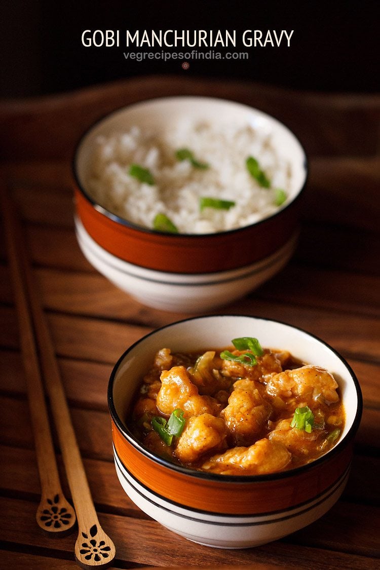 gobi manchurian gravy in a ceramic bowl placed next to wooden chopsticks