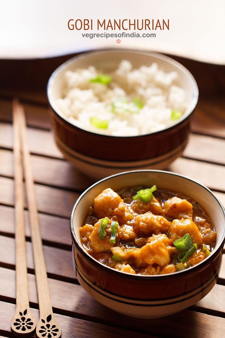 gobi manchurian gravy in a ceramic bowl placed next to wooden chopsticks