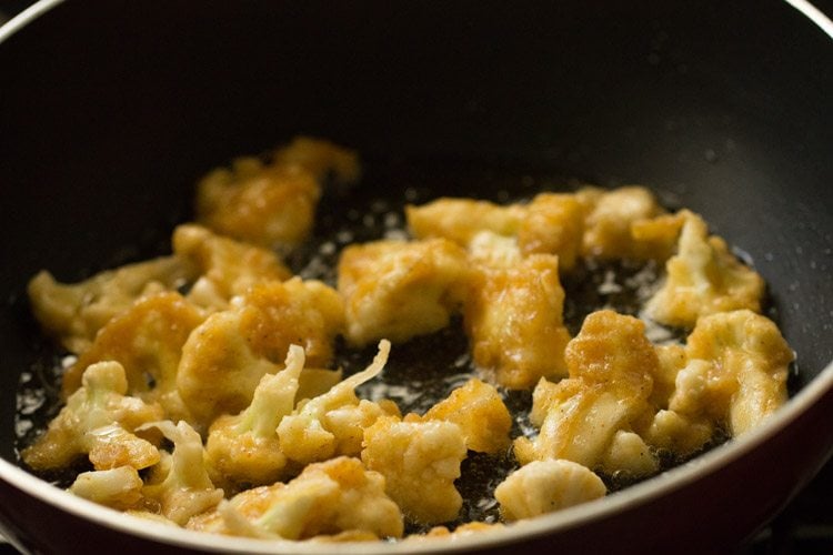 cauliflower florets frying in hot oil