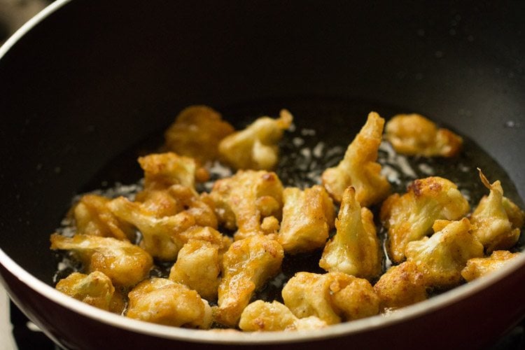 crispy golden gobi florets in hot oil