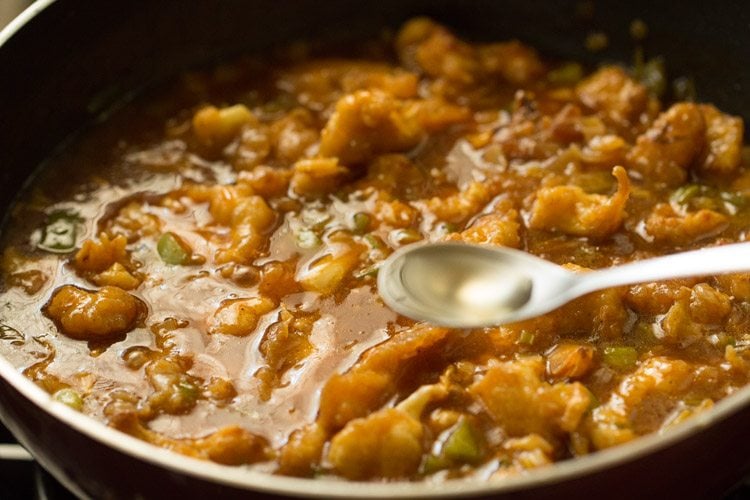 vinegar being added with a measuring spoon