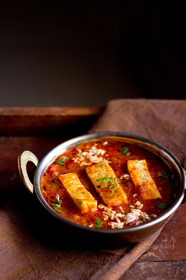 kadai paneer recipe gravy in a small copper kadai garnished with coriander sprigs