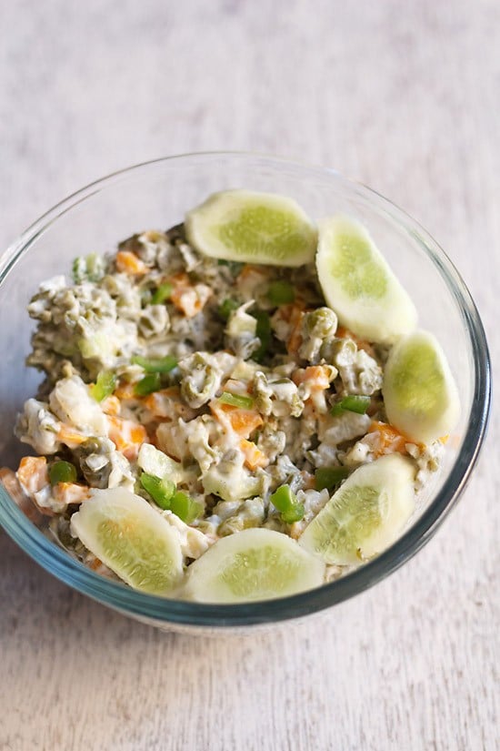 veg russian salad served in a glass bowl.