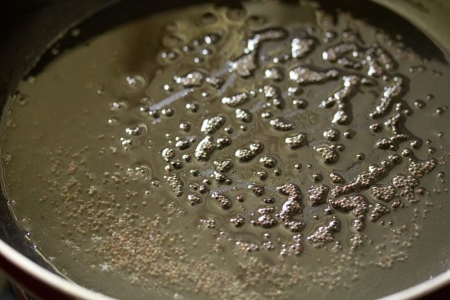 crackling mustard seeds in a frying pan