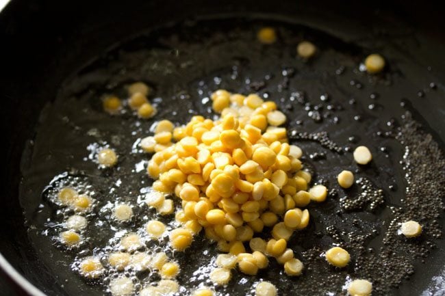 chana dal added to frying pan