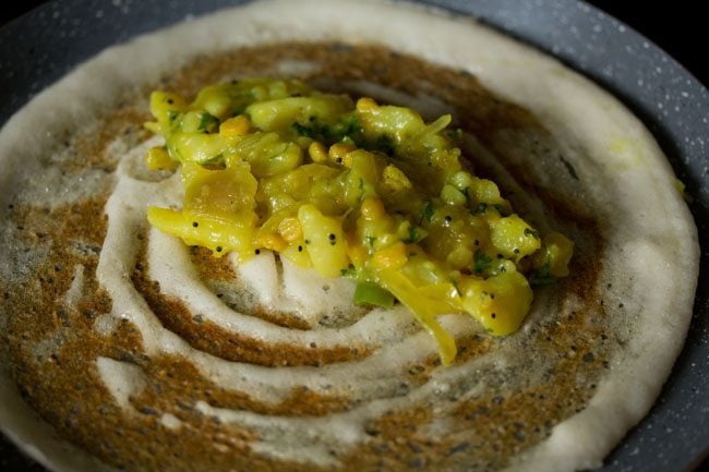 potato filling added to cooked dosa