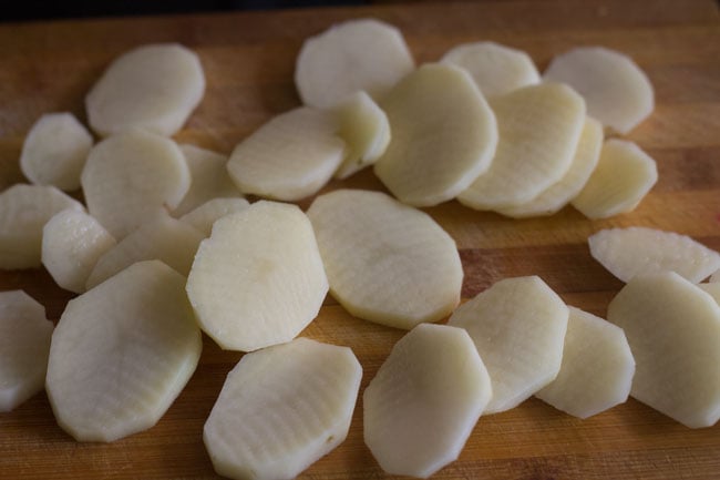 slice the potatoes on a chopping board