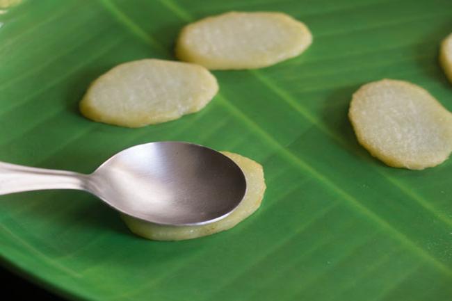 fried potato slices placed on a banana leaf