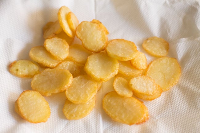 fried potato slices on kitchen paper towels