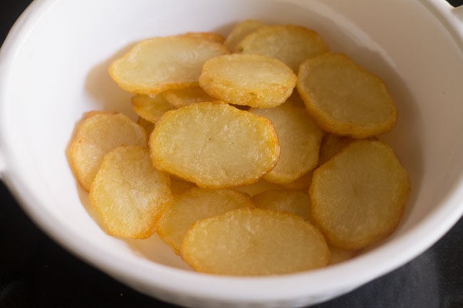 fried potato slices in a white bowl