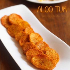 aloo tuk served on a white plate with text layover.