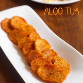 The aloo tuk is served on a white plate with the word stay on it.