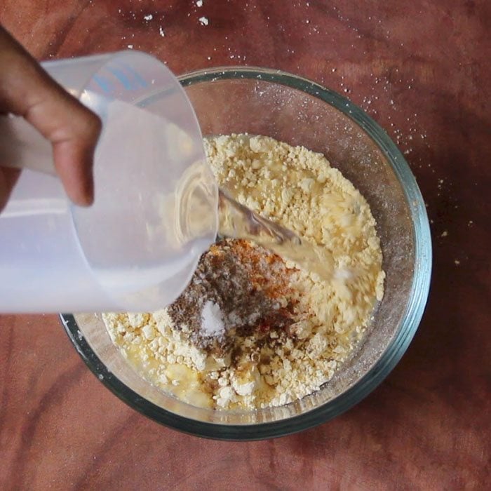 adding water to make pakora batter