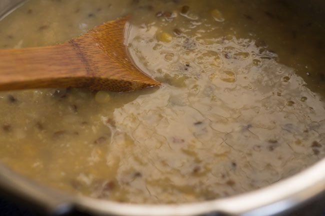 mashing the cooked lentils