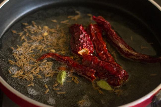 cloves chillies cardamom added to pan