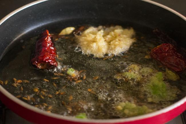 adding crushed ginger and green chili