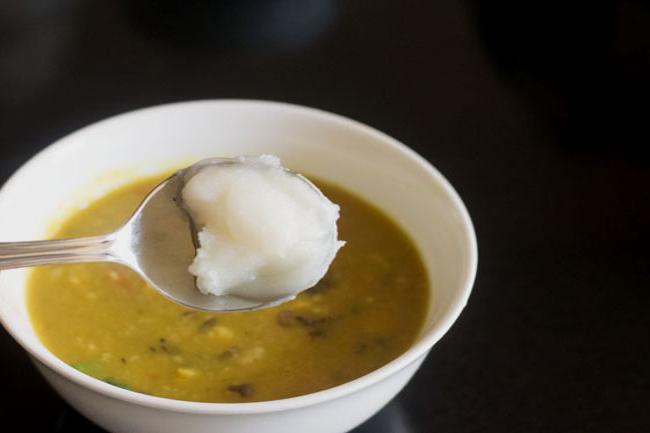 adding ghee to serving bowl containing panchmel dal