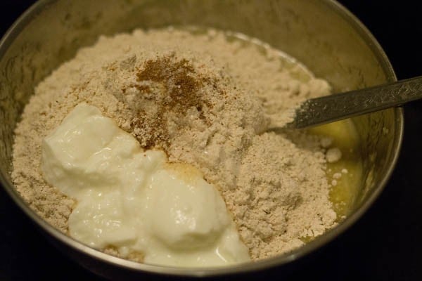 kneading dough with flour salt yogurt ghee in a bowl