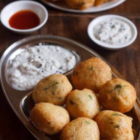 mix dal vada served on a steel plate with coconut chutney and text layover.