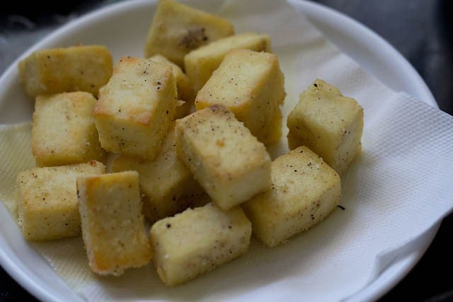 fried paneer cubes on kitchen paper towels